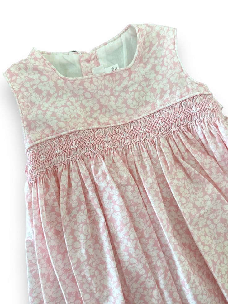 Reference: V064 Color: Pink Materials: 100% cotton Intended Age: Toddler Girl, Girl Description: This dress is perfect for spring & summer. The sleeveless dress has a smock strip on the waist in white and pink details. It has a square collar with piping and it has buttons in the back for fastening. Fully lined, hand smocked. Size Guide: Runs Small. Please size up +1 from your regular size. Smock Dress Pattern, Newborn Embroidery, Smocking Designs, Kids Smock, Smocking Dress, Smocking Tutorial, Smocking Plates, Hand Smocked Dress, Smocked Baby Dresses