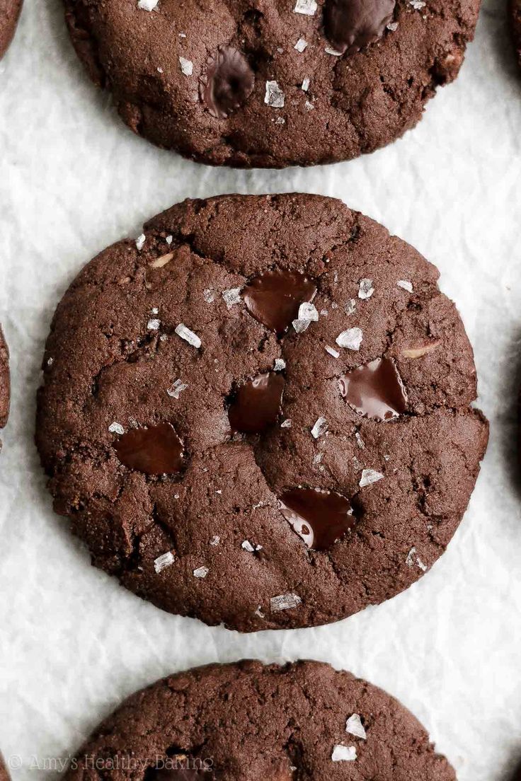 chocolate cookies with sprinkles are on a baking sheet and ready to be eaten