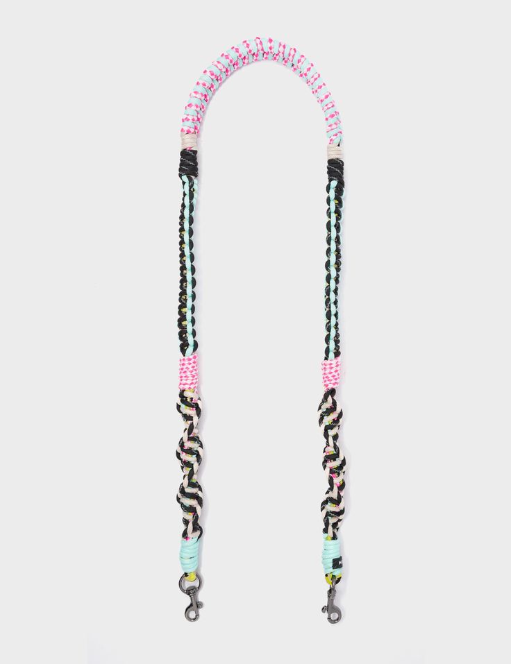 a pink, black and white beaded lanyard with an elephant charm on it