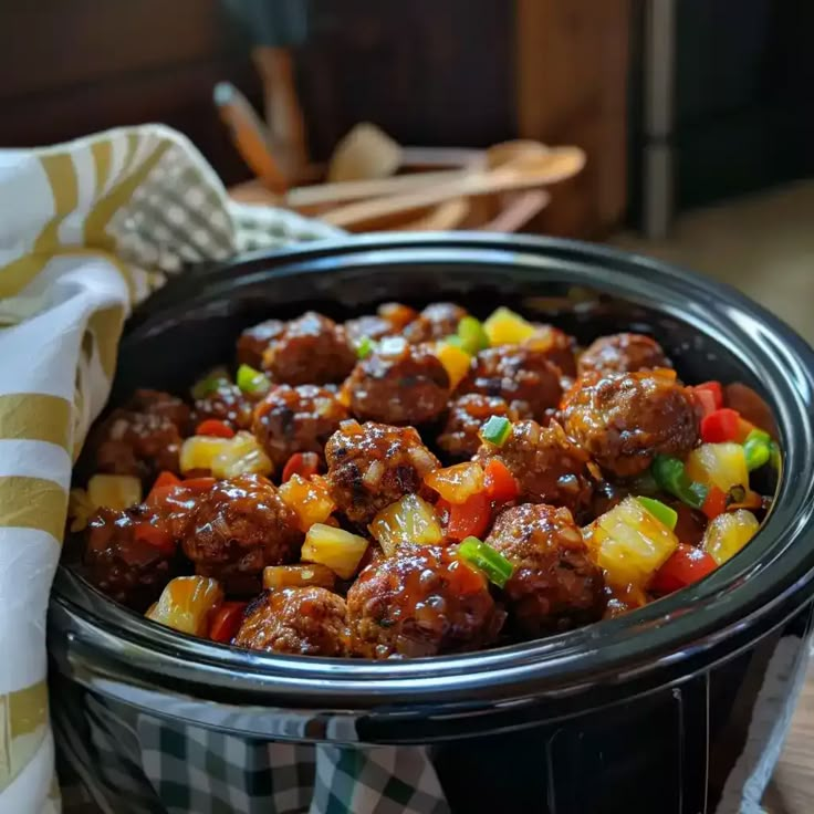 a pot filled with meat and vegetables on top of a table