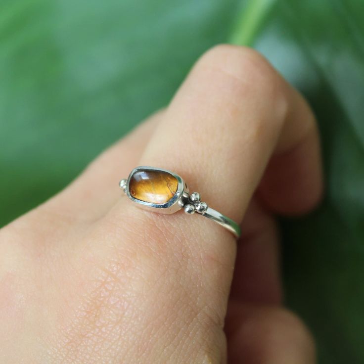 Material: Sterling silver - Tigers Eye Size Guide included as a photograph  Free UK first class postage Eco friendly packaging As all of our natural stones are created by Mother Nature, each stone is unique in appearance, so may look different from the stone photographed. Based in Dorset, UK Stackable Citrine Jewelry As Gift, Amber Crystal Gemstone Ring In Sterling Silver, Amber Crystal Sterling Silver Ring, Amber Crystal Ring With Sterling Silver, Amber Crystal Ring In Sterling Silver, Amber Birthstone Jewelry For Anniversary, Stackable Citrine Ring Jewelry, Dainty Citrine Ring Jewelry, Minimalist Amber Ring Jewelry