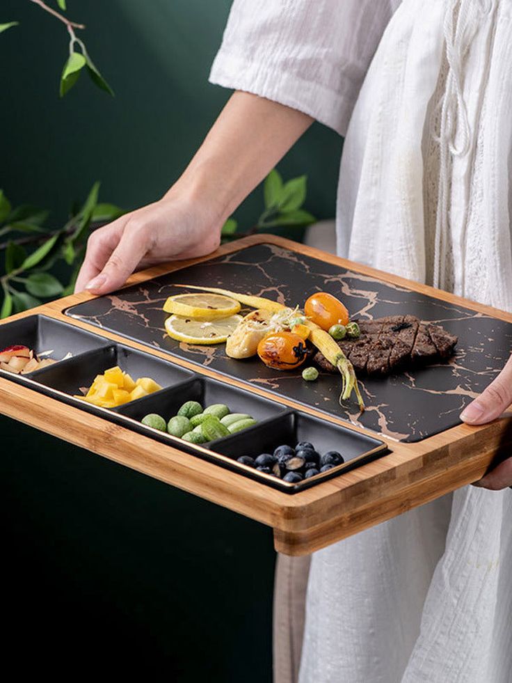 a person holding a tray with food on it