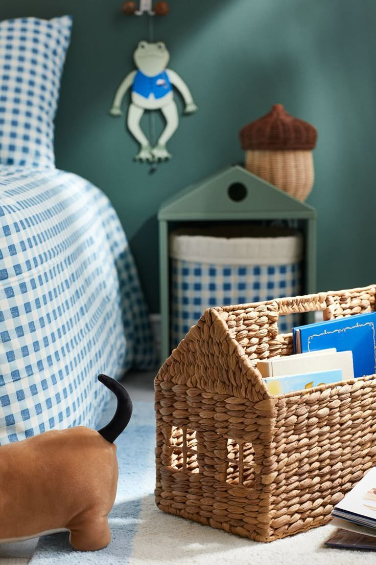 a toy dachshund is standing next to a basket with books in it