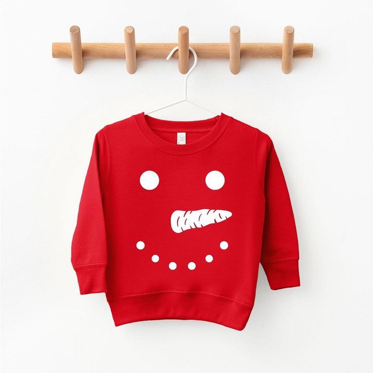 Looking for a cute sweatshirt for your kids? We have the perfect Snowman Face graphic sweatshirt addition to their closet! Red Long Sleeve T-shirt With Cartoon Print, Playful Fleece Tops For Winter, Playful Fleece Tops For Fall, Cute Red Winter Sweatshirt, Cute Red Sweatshirt For Winter, Playful Fleece Crew Neck Sweatshirt, Playful Fleece Sweatshirt With Crew Neck, Playful Red Sweatshirt For Fall, Fun Red Tops For Fall