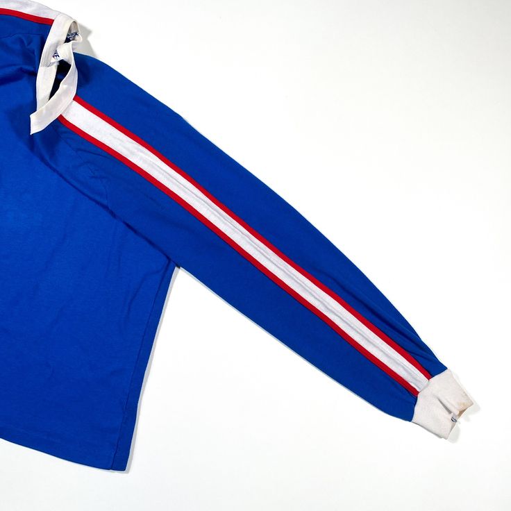 This is a vintage 1970s Nike Sportswear tshirt, it is in excellent condition and labeled as a size medium. Blue Cotton Top With Contrast Stripes, Cotton Athleisure Top With Side Stripes, Sporty Cotton T-shirt With Side Stripes, Blue Cotton Top With Striped Sleeves, Sportswear Crew Neck Top With Contrast Stripes, Sportswear Top With Contrast Stripes And Crew Neck, Varsity Crew Neck Top With Stripes, Varsity Style Tops With Contrast Stripes For Streetwear, Sporty Streetwear Tops With Contrast Stripes