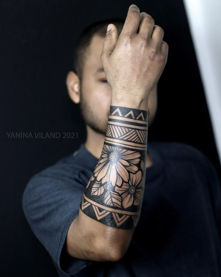 a man with a tattoo on his arm is holding his hand up to the camera