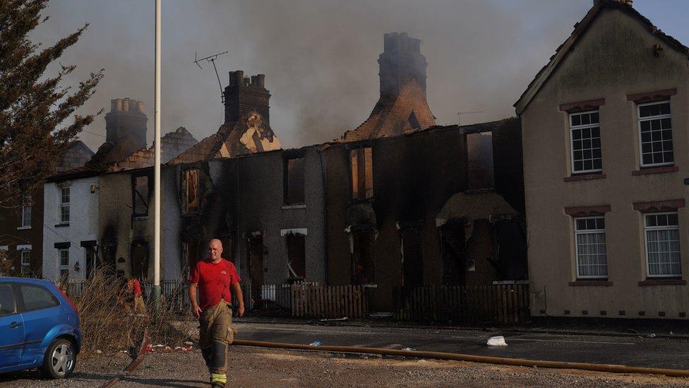 Firefighters at the scene of a blaze in the village of Wennington, east London