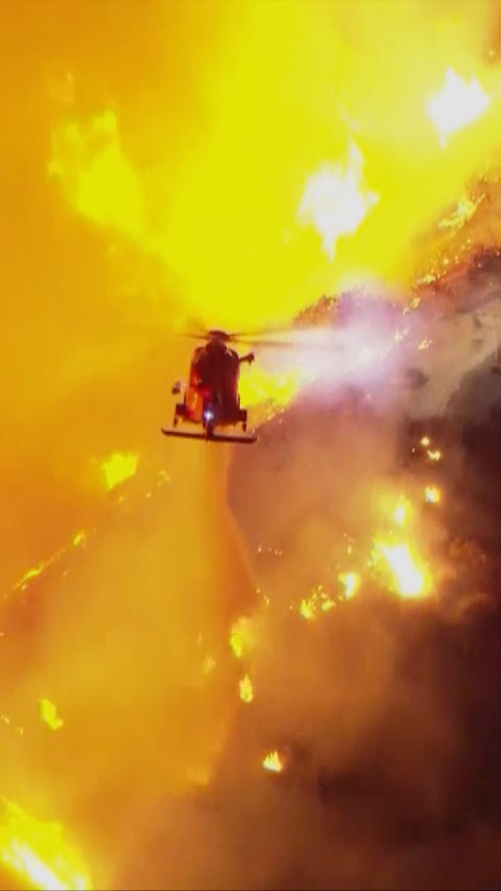 Helicopter dropping water on Hollywood Hills fire