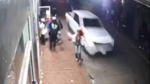 People run to escape as car is driven at speed down New Orleans street