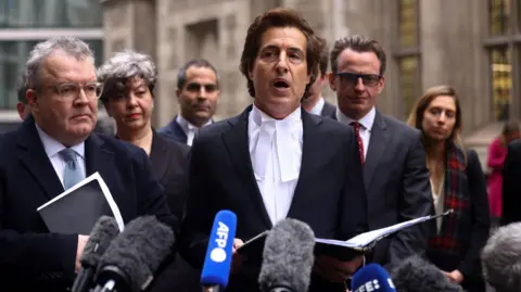 Reuters Lawyer David Sherborne read a statement outside court where the case would have been held