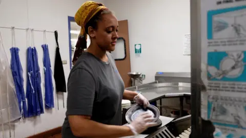 Holly Honderich College student cleaning dishes