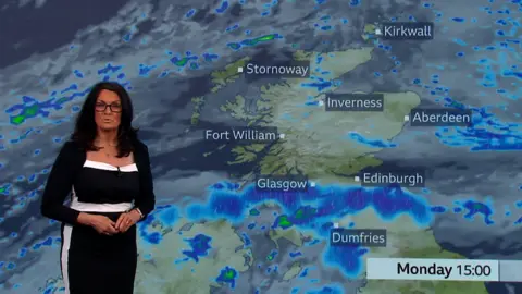 Judith Ralston presents the weather showing heavy rain forecast over the central belt. She wears a black and white dress.