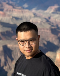 Photo of Timothy with some mountains in the background.