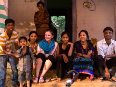 UM student studying abroad and sitting with local residents