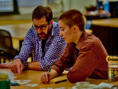 a teacher working with a student.