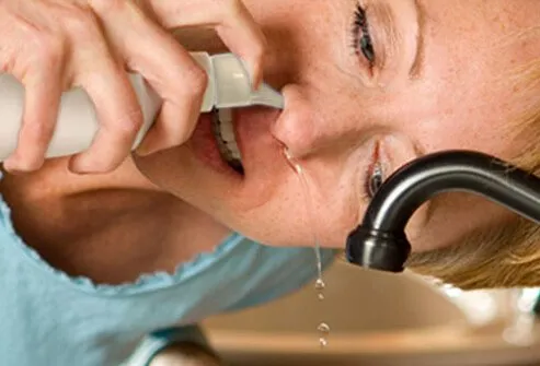 A woman with solution coming out of her nose.