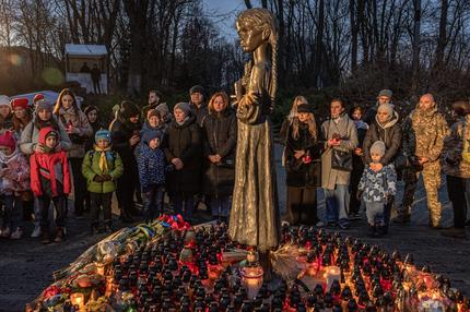 Holodomor: People pay tribute in front of the 'Bitter Memory of Childhood' child statue to the victims of the famine of 1932-1933 at the National Museum of the Holodomor-Genocide in Kyiv, on November 25, 2023, amid the Russian invasion of Ukraine. Ukraine marked 90 years since the Stalin-era Holodomor famine, one of the darkest momments in it's history that left millions dead. Ukrainian President Volodymyr Zelensky said on November 25, 2023 it was "impossible" to forgive the "crimes of genocide" during a famine that took place under the rule of Soviet dictactor Joseph Stalin.