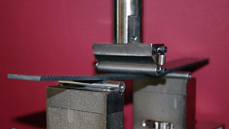 Flexural testing of a metal bar sample