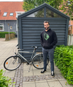 A student standing next to his bike