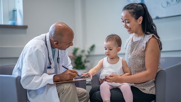 doctor with mother and child in a doctors office