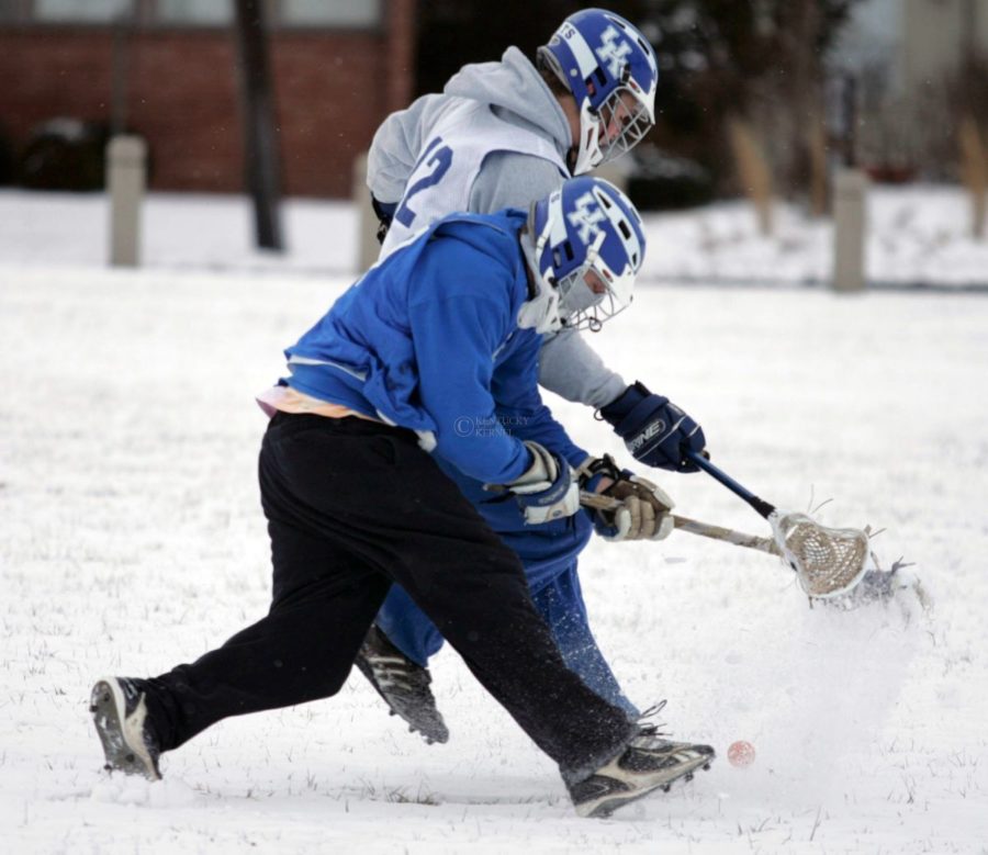 Physics sophomore Nate Bussard (front) and mechanical engineering freshman Eddie Alvarez fight for a loose ball during the lacrosse practice at Goodbarn field on Wednesday. Photo by Zach Brake