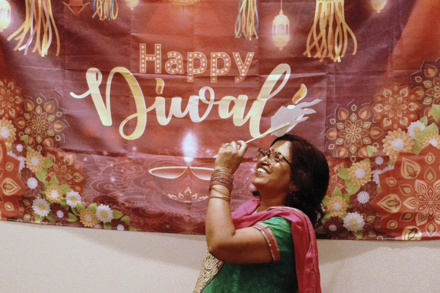 Poonam Gupta poses for a polaroid photo at the ISA Diwali celebration on Friday, Nov. 4, 2022, at the University of Kentucky Gatton Student Center in Lexington, Kentucky. Photo by Samuel Colmar | Kentucky Kernel