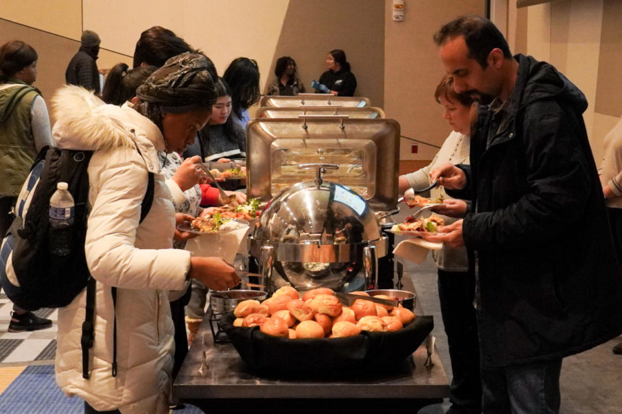 Guests make plates of food at the UK Alumni Thanksgiving dinner on Tuesday, Nov. 22, 2022, at the Gatton Student Center Ballroom in Lexington, Kentucky. Photo by Bryce Towle | Kentucky Kernel