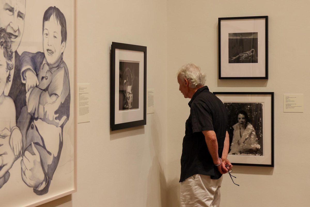 78 year old Joe Anthony admires the Family Dynamics exhibit at the Singletary Center in Lexington, Kentucky, on Friday, Aug. 30, 2024. Photo by Sydney Yonker | Staff