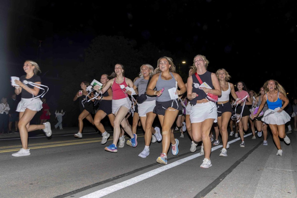 New sorority members run to their new houses during bid day on Monday, Sept. 9, 2024, at Greek Row in Lexington, Kentucky. Photo by Matthew Mueller | Staff