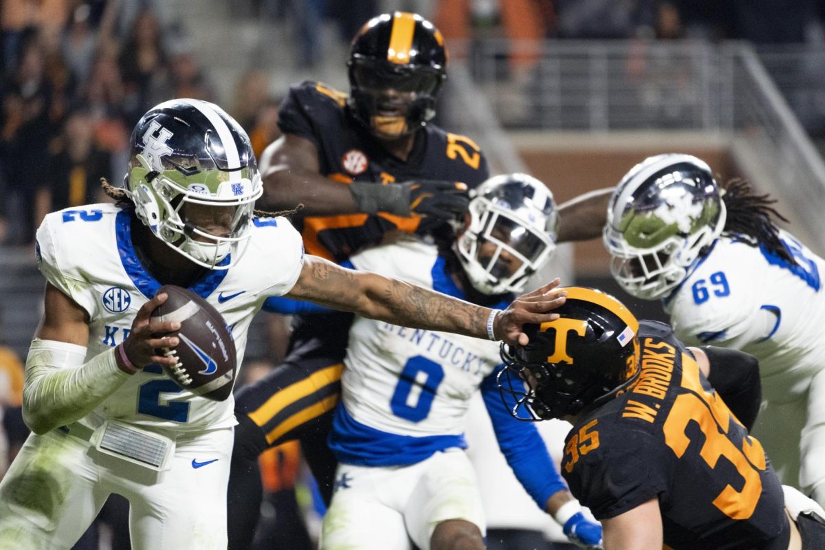 Kentucky Wildcats quarterback Gavin Wimsatt (2) runs with the ball while holding off Tennessee defensive back Will Brooks (35) during the Kentucky vs. Tennessee football game on Saturday, Nov. 2, 2024, at Neyland Stadium in Knoxville, Tennessee. Kentucky lost 28-18. Photo by Christian Kantosky | Staff