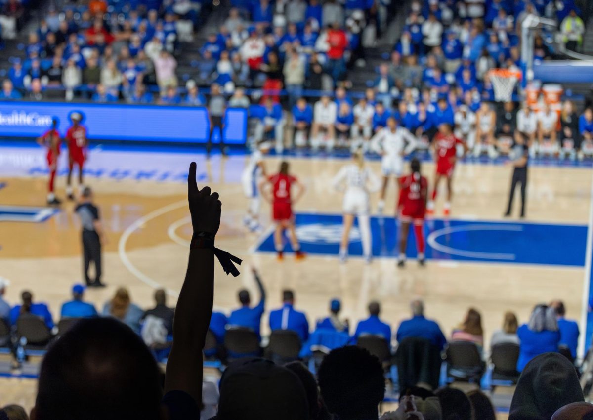 Kentucky Wildcats fan waves a "one" in the air while Wildcats guard, Dazia Lawrence (10), shoots a free-throw during the Kentucky vs. Louisville women's basketball game on Saturday, Nov. 16, 2024, at Historical Memorial Coliseum in Lexington, Kentucky. Kentucky won 71-61. Photo by Nathan Jones. | Staff