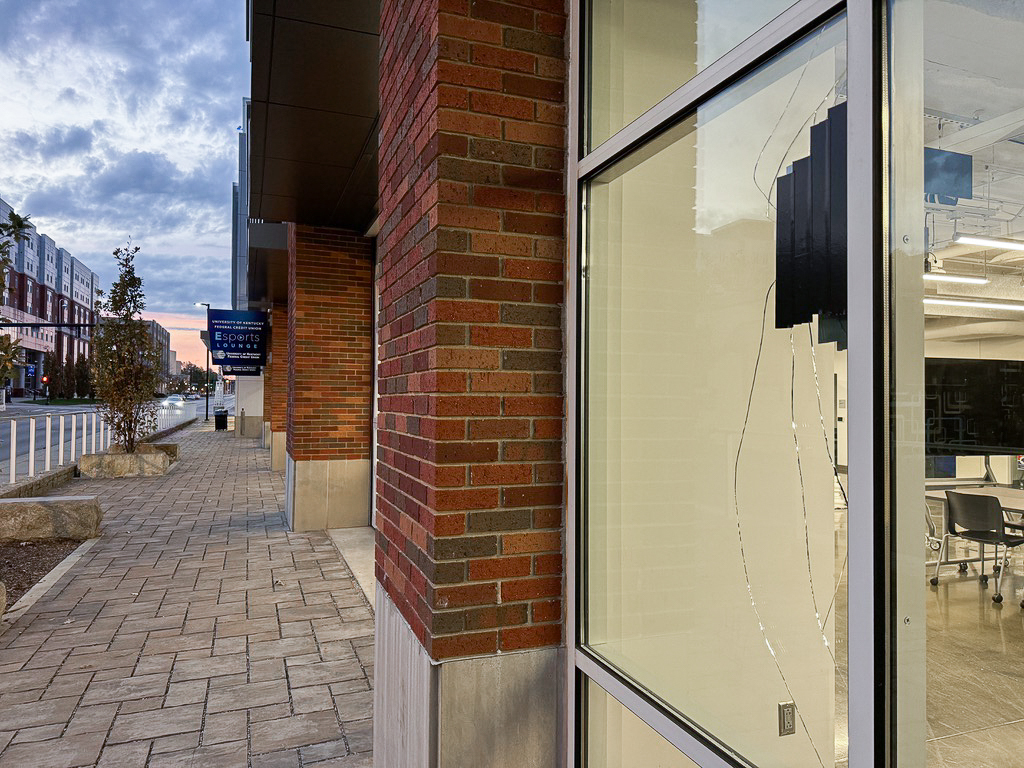 Tape patches bullet holes in the Cornerstone Parking Structure window after a shooting at Raising Canes across Winslow Street on Sunday, Nov. 3, 2024, at the University of Kentucky in Lexington, Kentucky. Photo by Abbey Cutrer | Staff