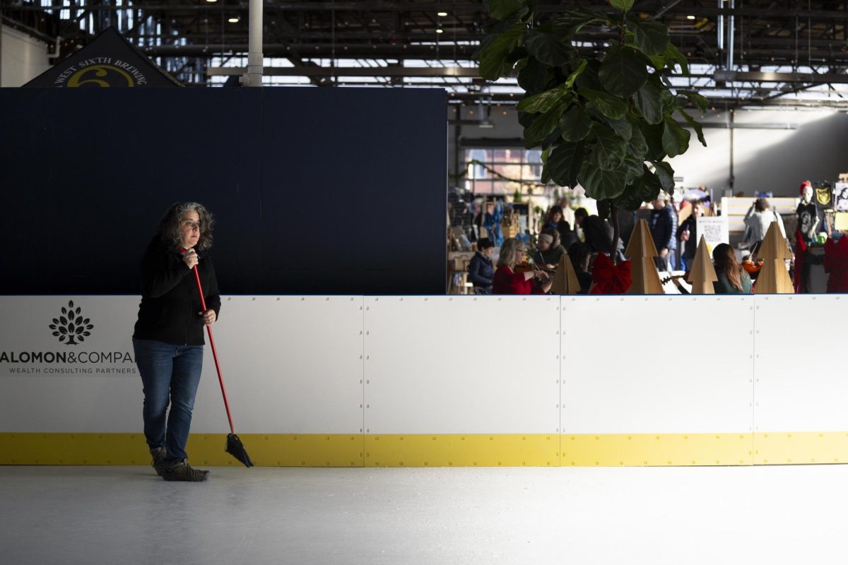 An employee sweeps the indoor ice rink during the Crafted Social Winter Market on Saturday, Dec. 7, 2024, at Greyline Station in Lexington, Kentucky. Photo by Christian Kantosky | Assistant Photo Editor