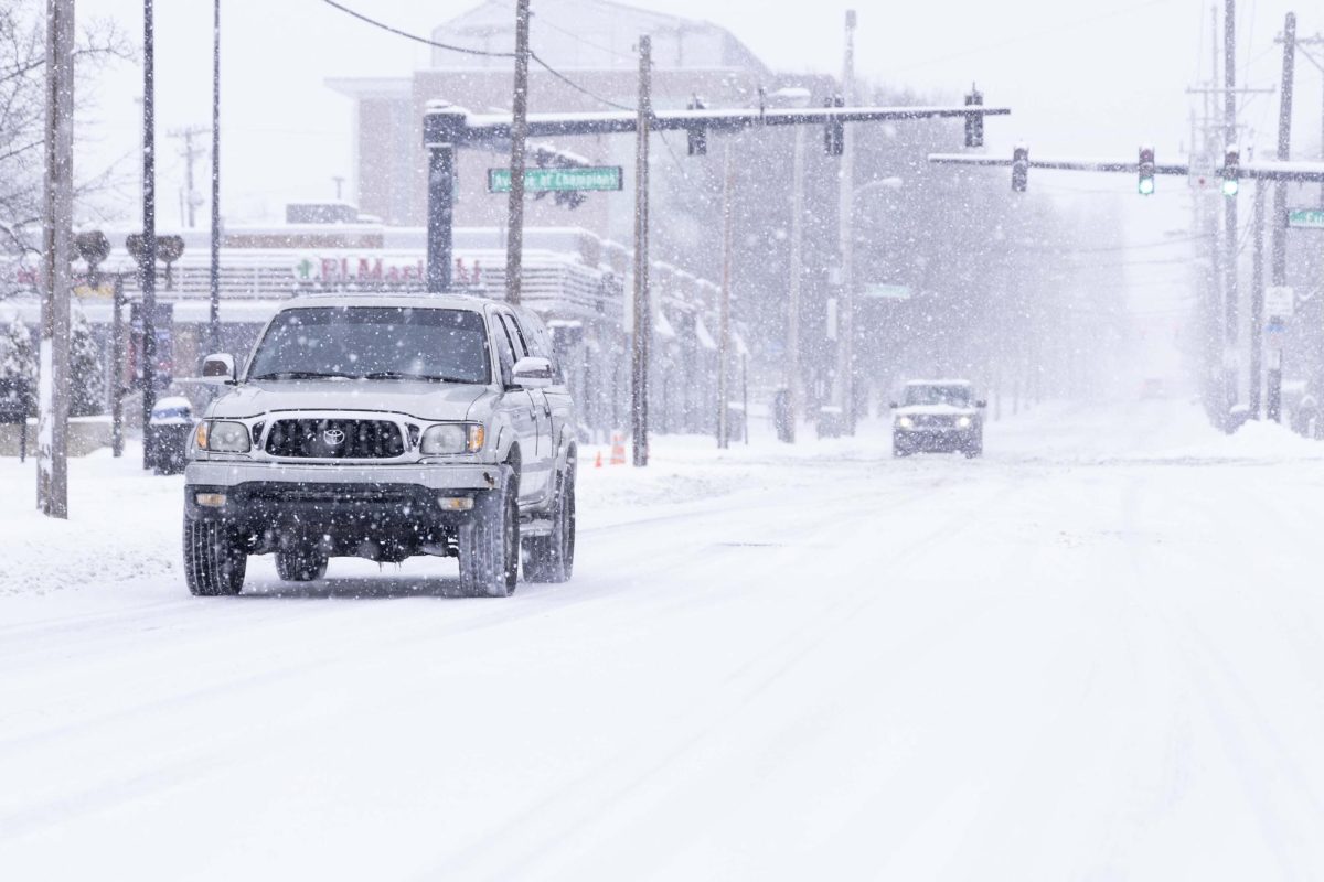 Vehicles navigate themselves through the snow during a snowstorm that hit the greater area of Lexington on Sunday, Jan. 5, 2025, at the University of Kentucky in Lexington.  Photo by Matthew Mueller | Photo Editor