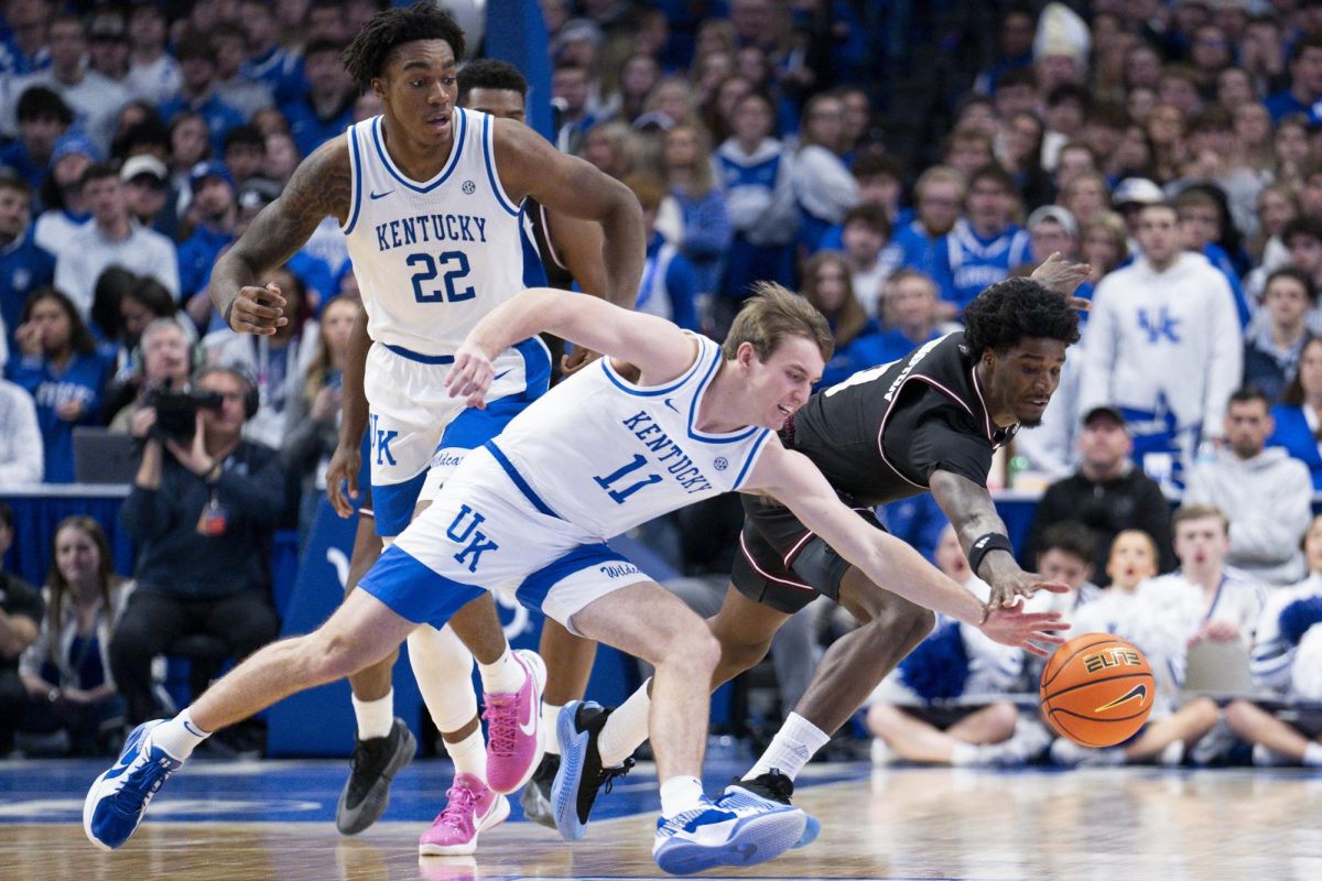 Kentucky Wildcats guard Travis Perry (11) struggles with Texas A&M Aggies forward Solomon Washington (9) during the basketball game vs. Texas A&M on Tuesday, Jan. 14, 2025, Rupp Arena in Lexington, Kentucky. Kentucky won 81-69. Photo by Christian Kantosky | Assistant Photo Editor