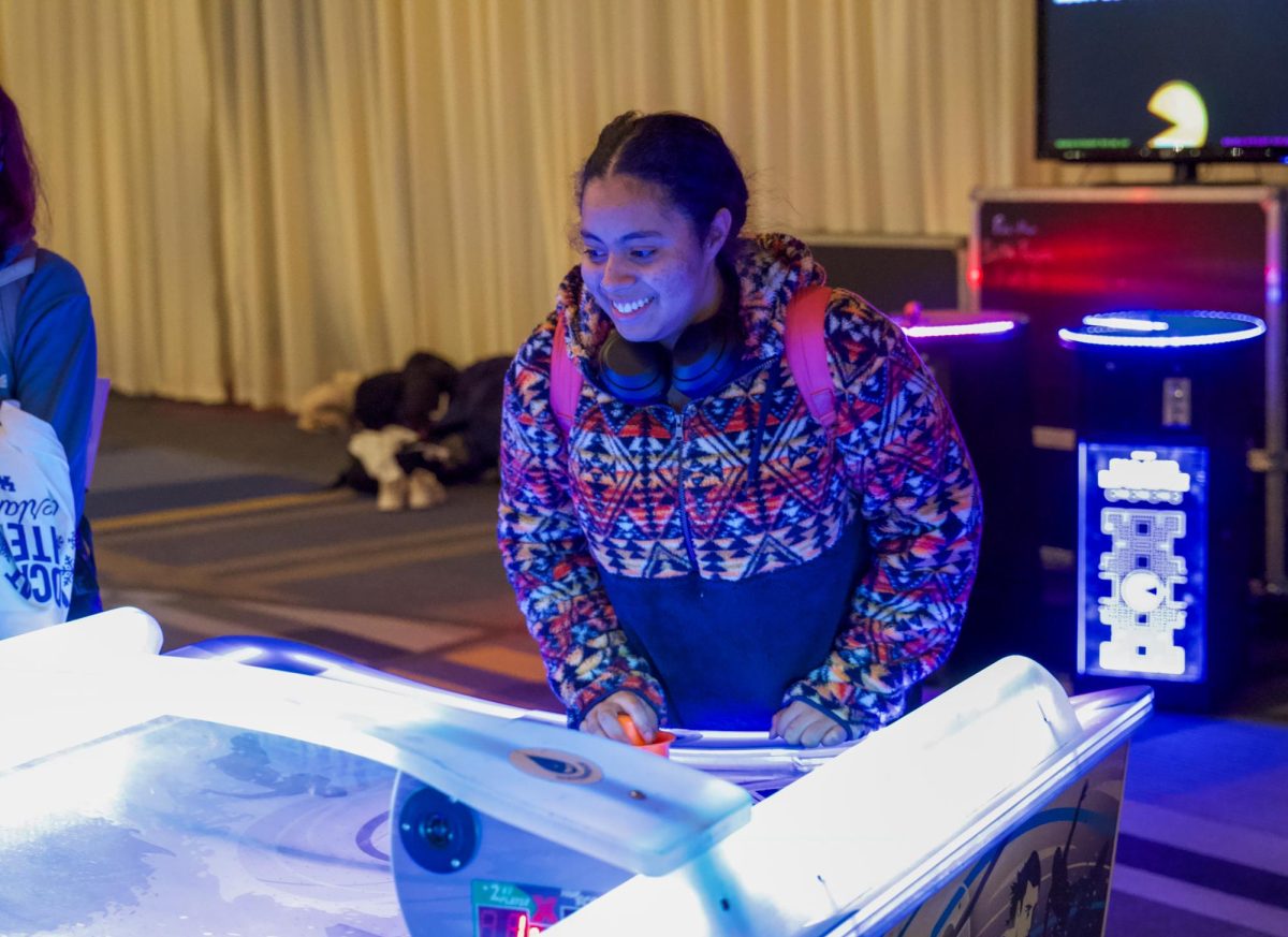 Freshman Izzy Layva plays air hockey at Wildcat Winter Wonderland on Thursday, Jan. 16, 2025, at the Gatton Student Center Ballroom. Photo by Brayden Finn | Staff