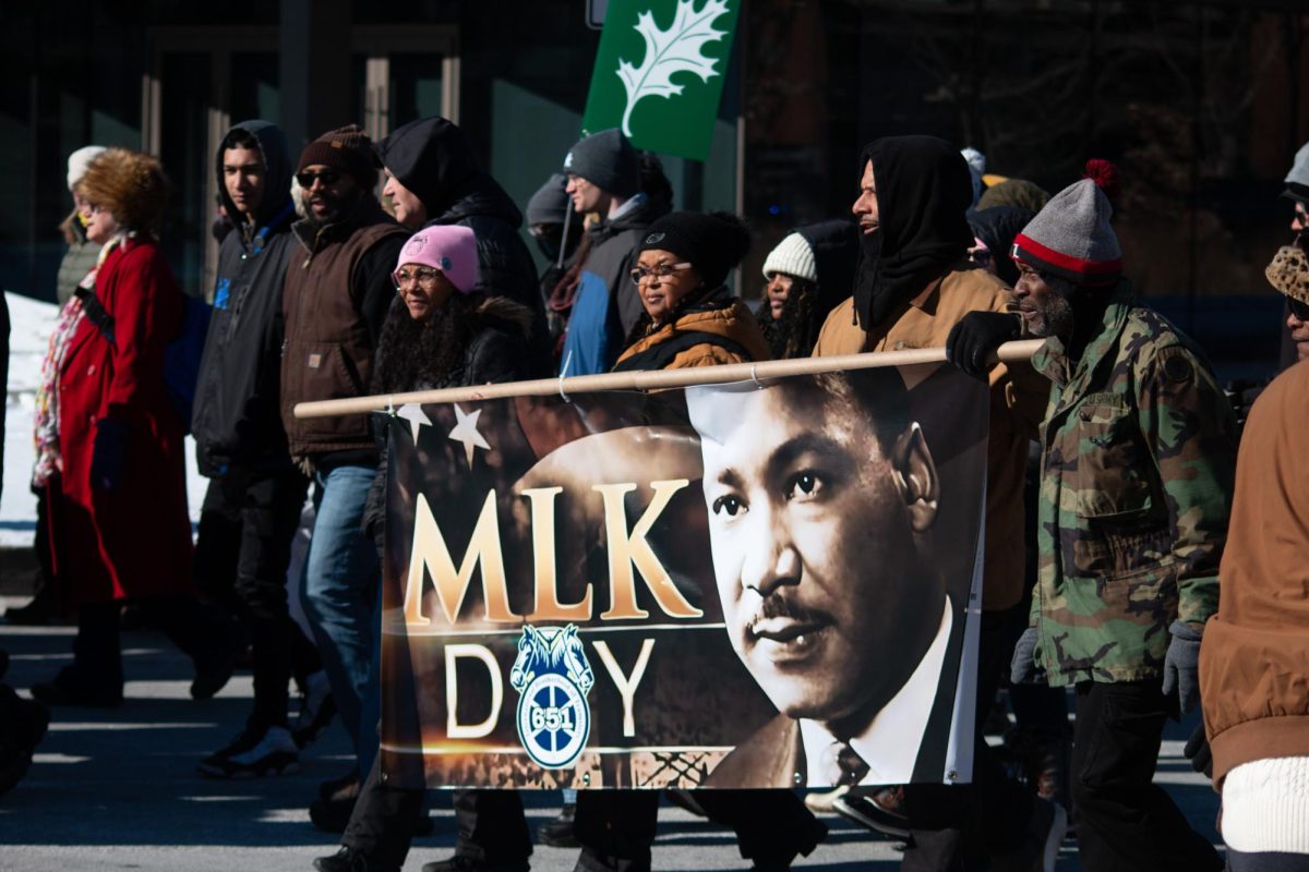 Lexington residents hold an MLK day sign during the Martin Luther King Jr. Day Freedom March on Monday, Jan. 20, 2025, in downtown Lexington, Kentucky. Photo by Chloe Bradley | Staff