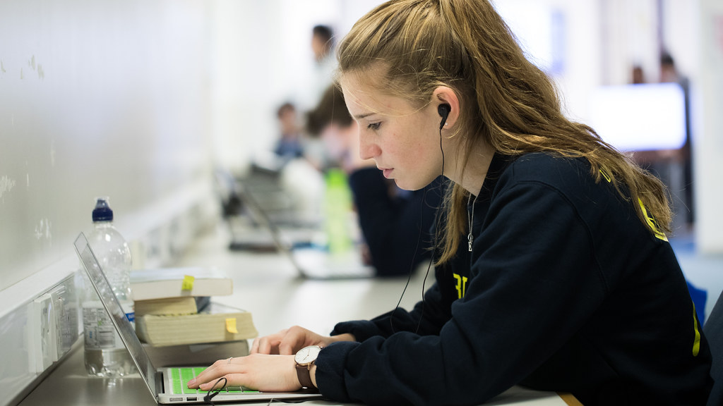 A student typing on a laptop.