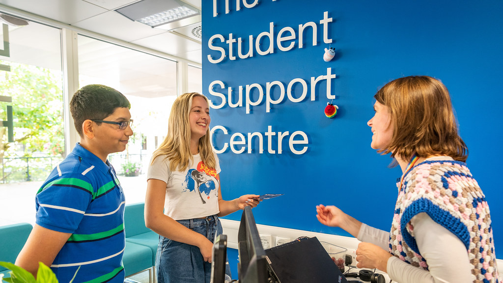 A student advisor talks to two students