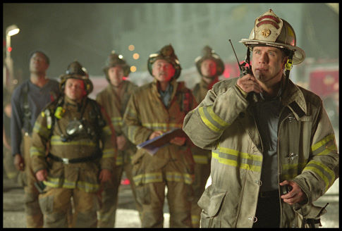 Captain Mike Kennedy (John Travolta, right) mobilizes his team to rescue their trapped comrade.