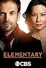 Jonny Lee Miller and Lucy Liu in Elementary (2012)