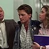 Michael J. Fox, James Tolkan, and Claudia Wells in Back to the Future (1985)