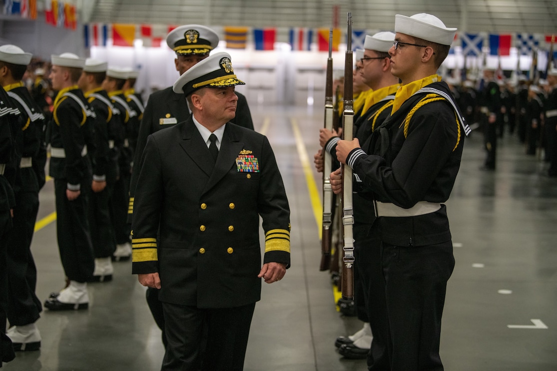 Vice Admiral Rick Cheeseman, Chief of Naval Personnel, reviews the recruit ceremonial honor guard during a pass-in-review graduation ceremony during a visit to Recruit Training Command (RTC) Great Lakes, Illinois, Nov. 11, 2022.