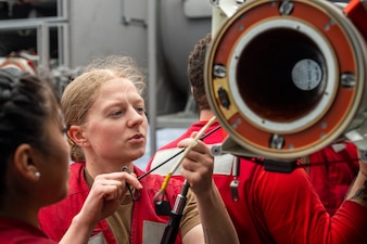 Sailors upload a NATO Sea Sparrow missile aboard USS Carl Vinson (CVN 70) in the Philippine Sea.