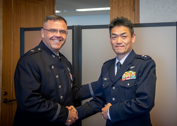 Japan Air Self-Defense Force Maj. Gen. Takahiro Kubota, Air Staff Office Defense Planning and Policy Department director general, and U.S. Space Force Brig. Gen. Anthony Mastalir, commander of U.S. Space Forces Indo-Pacific, shake hands prior to a Space Force engagement at the Ministry of Defense building in Tokyo, Japan, Dec. 2, 2024. The discussion centered on activation initiatives and strengthening bilateral cooperation in space operations. (U.S. Air Force photo by Airman 1st Class Cayla Hunt)