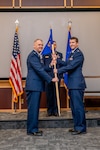 a man hands another man a flag