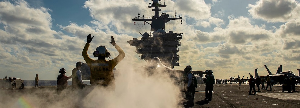 Aviation Boatswain’s Mate (Handling) 2nd Class Sitley Deleon, of Fresno, Calif., signals to an F-35C Lightning II on the flight deck aboard the Nimitz-class aircraft carrier USS Carl Vinson (CVN 70) Dec. 16, 2024.