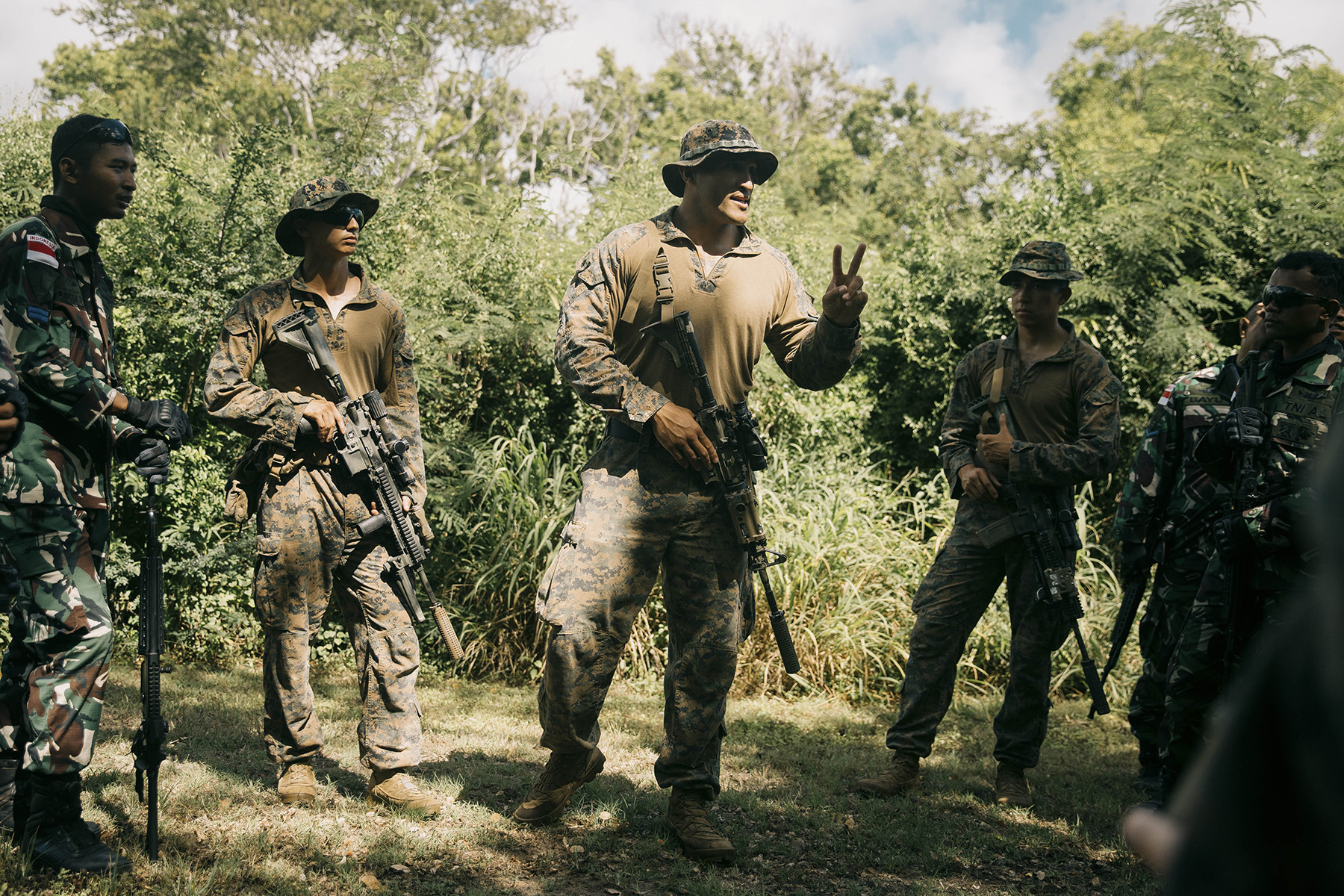 Marine Corps Sgt. Idan Urrutia explains patrol tactics to Indonesian marines during a patrolling exercise as part of Rim of the Pacific 2024 at Marine Corps Training Area Bellows in Waimanalo, Hawaii, June 28, 2024.