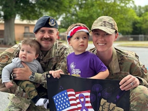 U.S. Air Force Master Sgt. Scott Brakefield, 42nd Security Forces Squadron kennel master and his spouse, Tech. Sgt. Renna Brakefield, Headquarters Air Force, Air Force Judge Advocate General's School paralegal instructor, pose for a photograph with their two sons, Wesley, left, and Harrison, right, at Robins Air Force Base, Georgia, May 15, 2023.