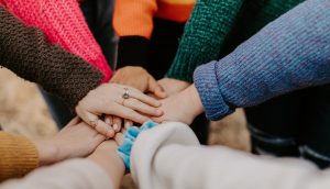 hands piled together in solidarity